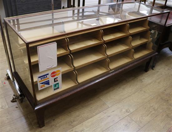 A glazed shop cabinet with drawers, W.178cm